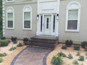 front door with landscaping and walkway