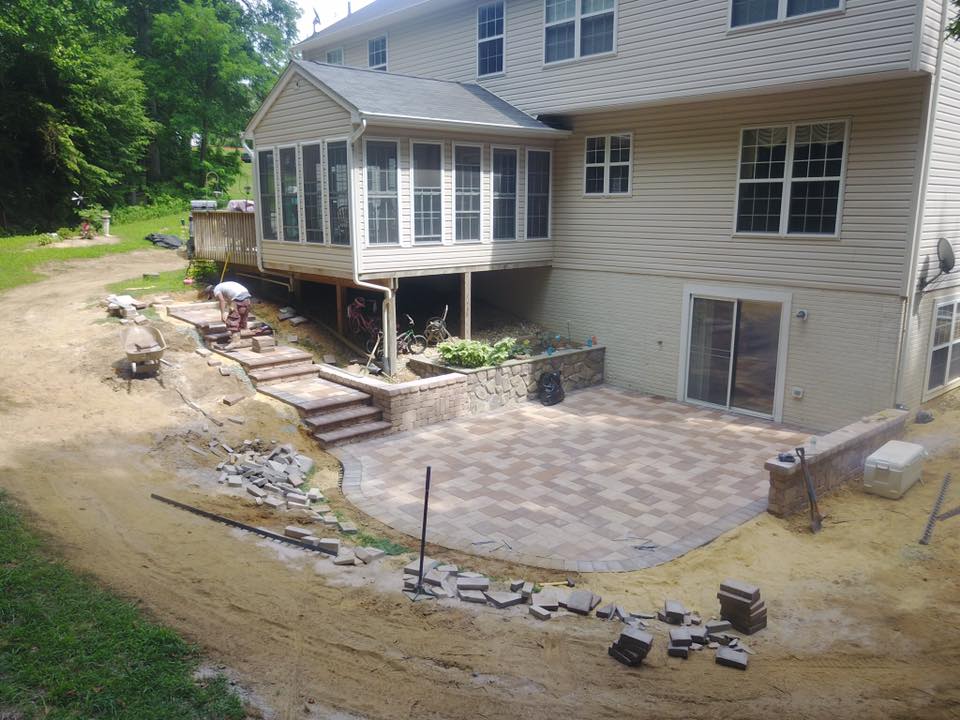 Patio being built, leading out from basement doors