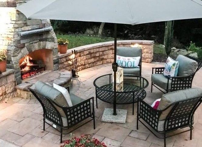 patio image with chairs and table and outdoor fireplace