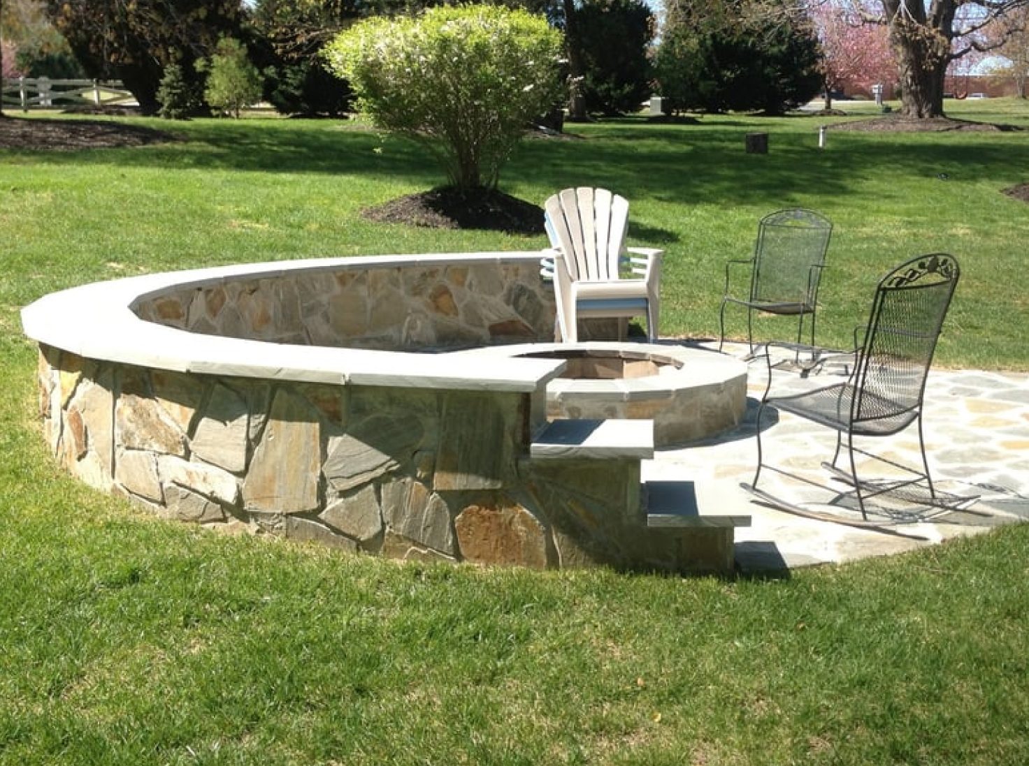 Circular patio around fire pit with chairs