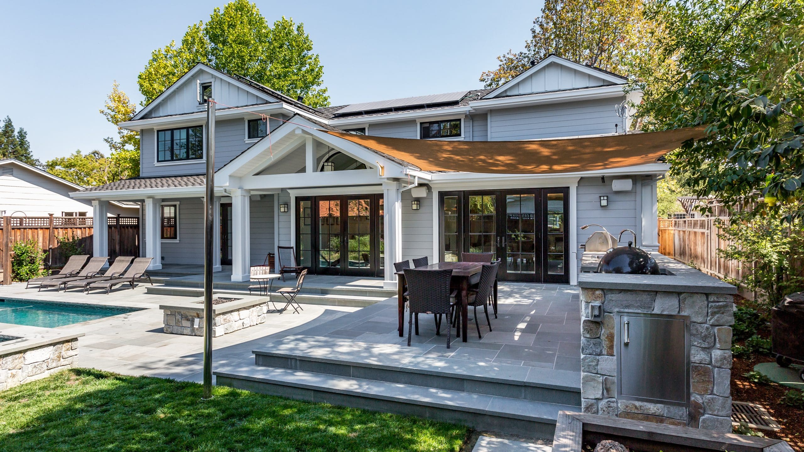 Picture of backyard with outdoor kitchen, firepit, patio and pool